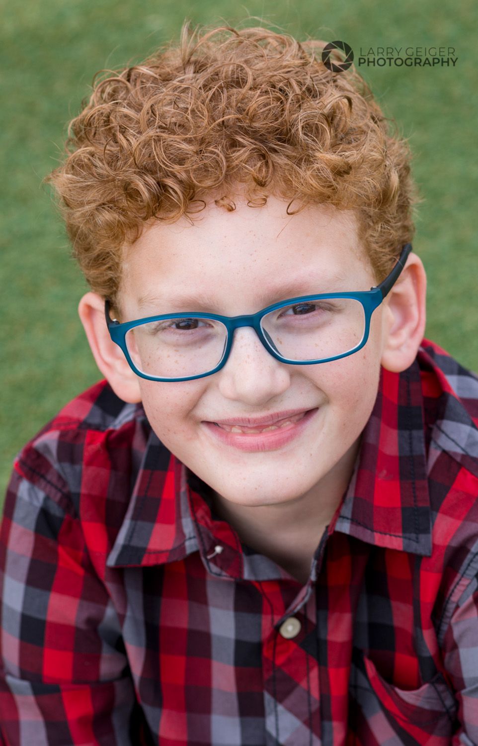 Child smiling during Houston portrait session, playful candid moment outdoors.