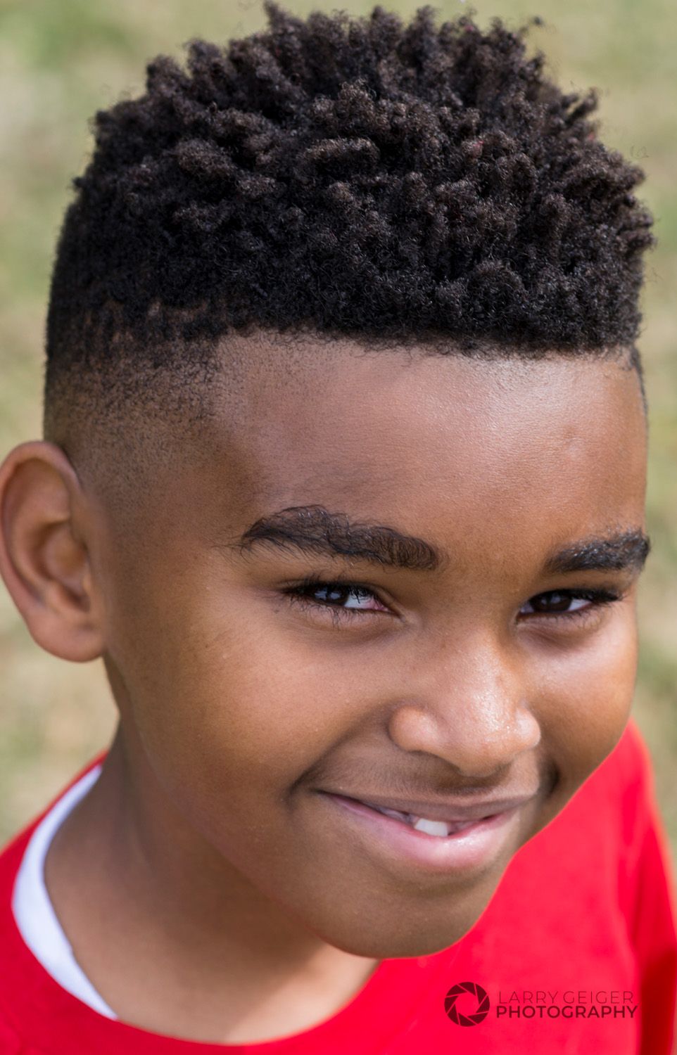 Kid laughing in Sugar Land park, bright natural light, lifestyle style.