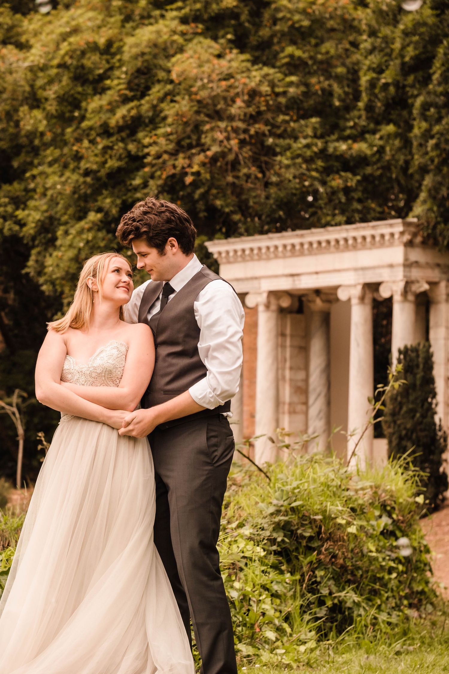 Couple walking along Lloyd Lake during their fantasy-inspired styled session in Golden Gate Park.