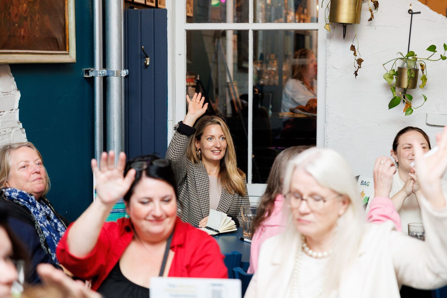 A collage of candid party photos showing people laughing and socializing at a festive indoor gathering.