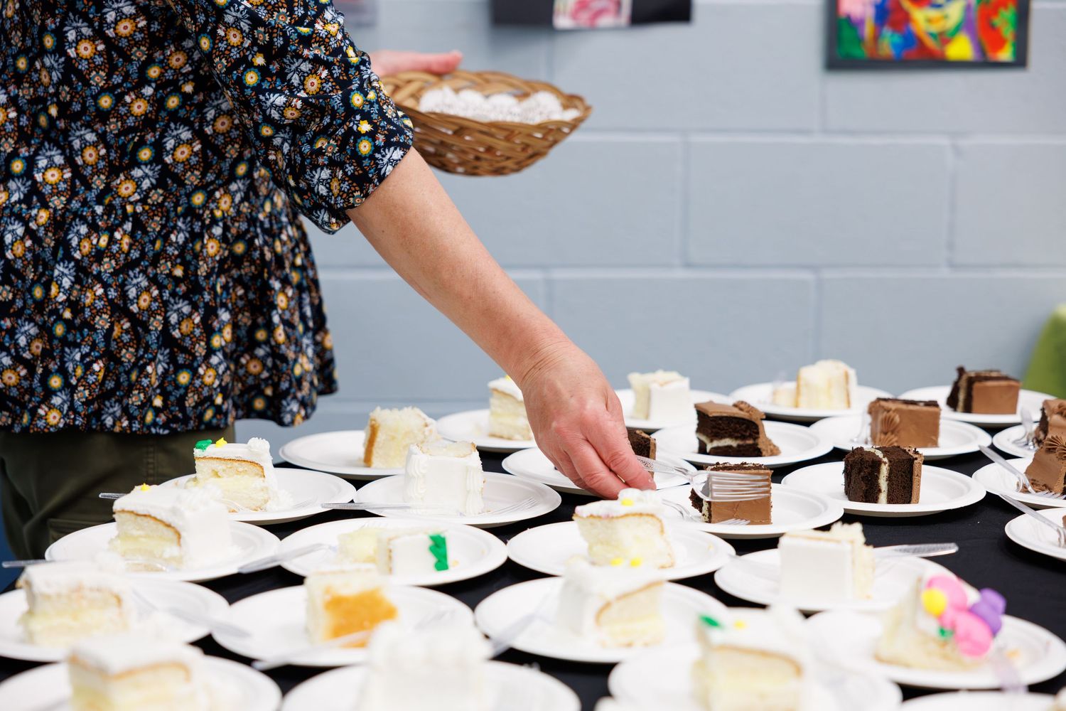 A long table is set with multiple plates of food and desserts for a buffet-style gathering.