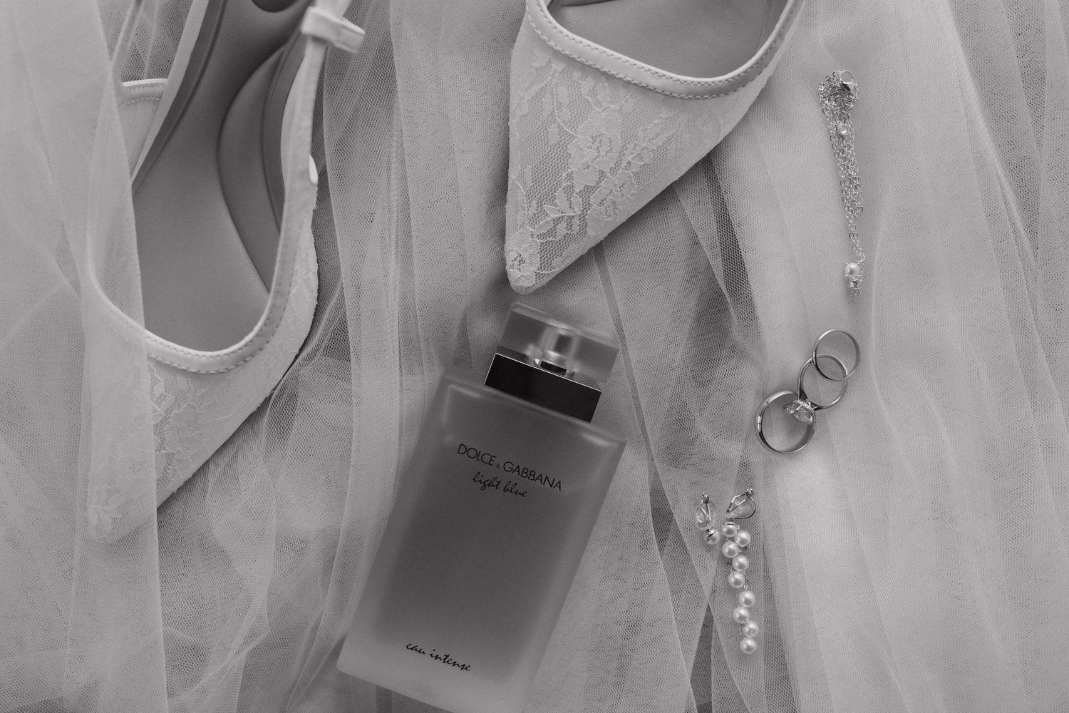 Bridal shoes, perfume, and veil styled during the getting ready at Blue Venado Riviera Maya wedding.