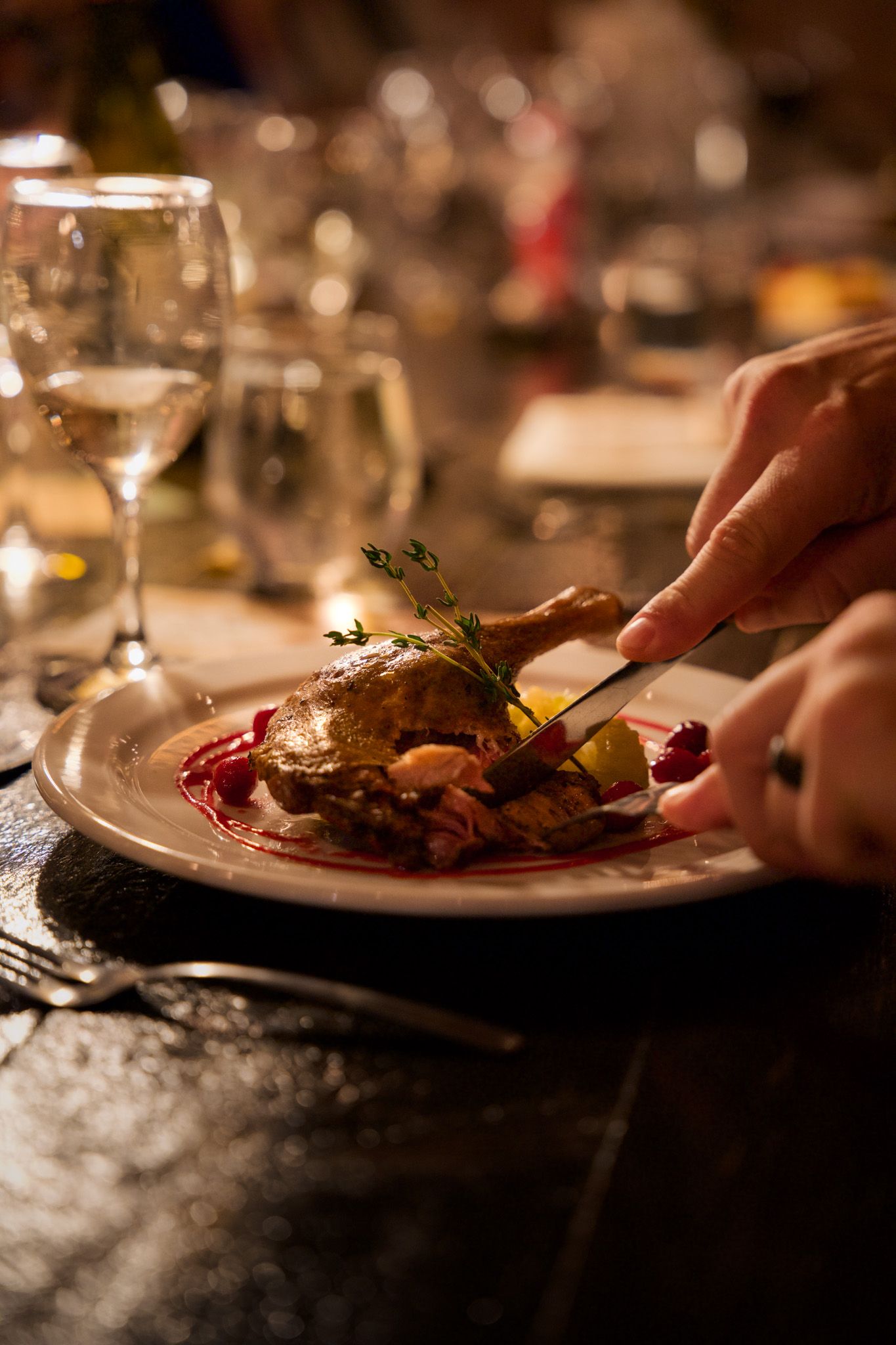 Close-up of plated gourmet food being served at an upscale dinner event.