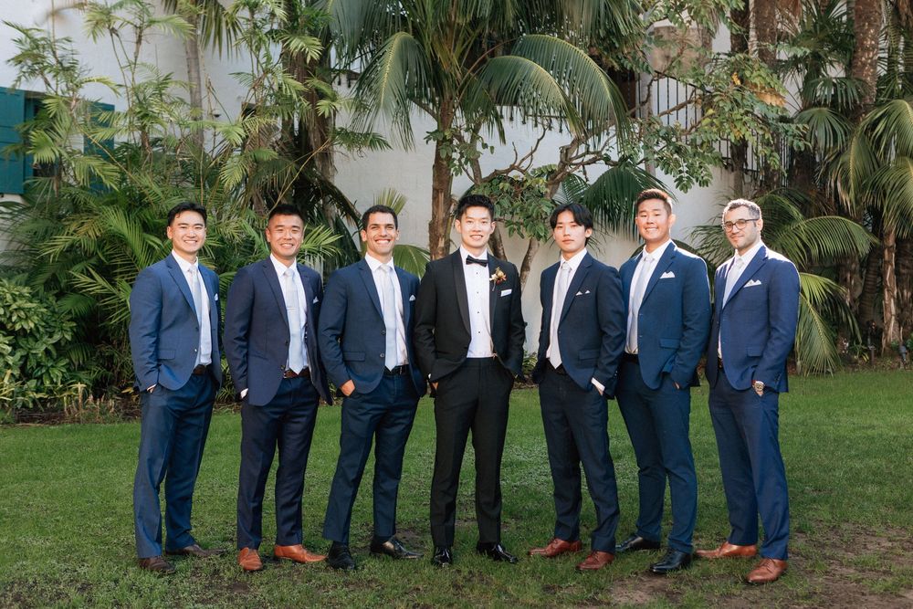 A group of groomsmen stand together for a wedding at the Sunken Gardens in Santa Barbara