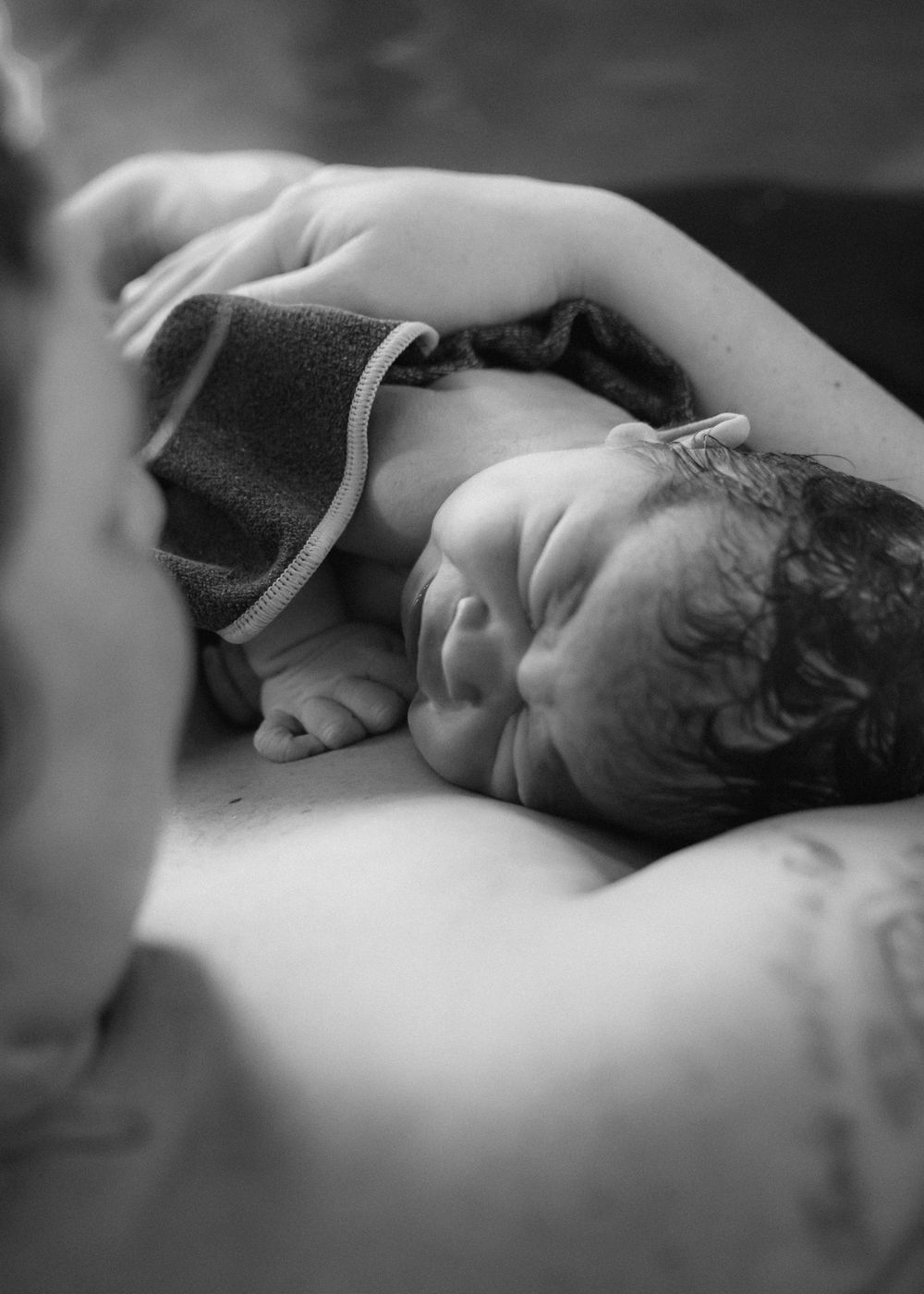 Black and white intimate newborn photography session.