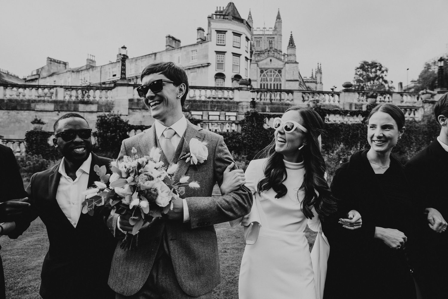 Relaxed group photo with friends after a Bath Guildhall ceremony at Parade Gardens