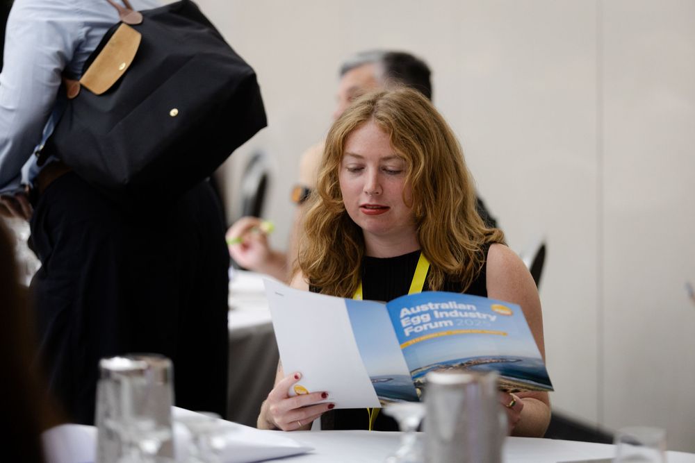 Fremantle Conference Photographer capturing a lady reading pamphlet at an event