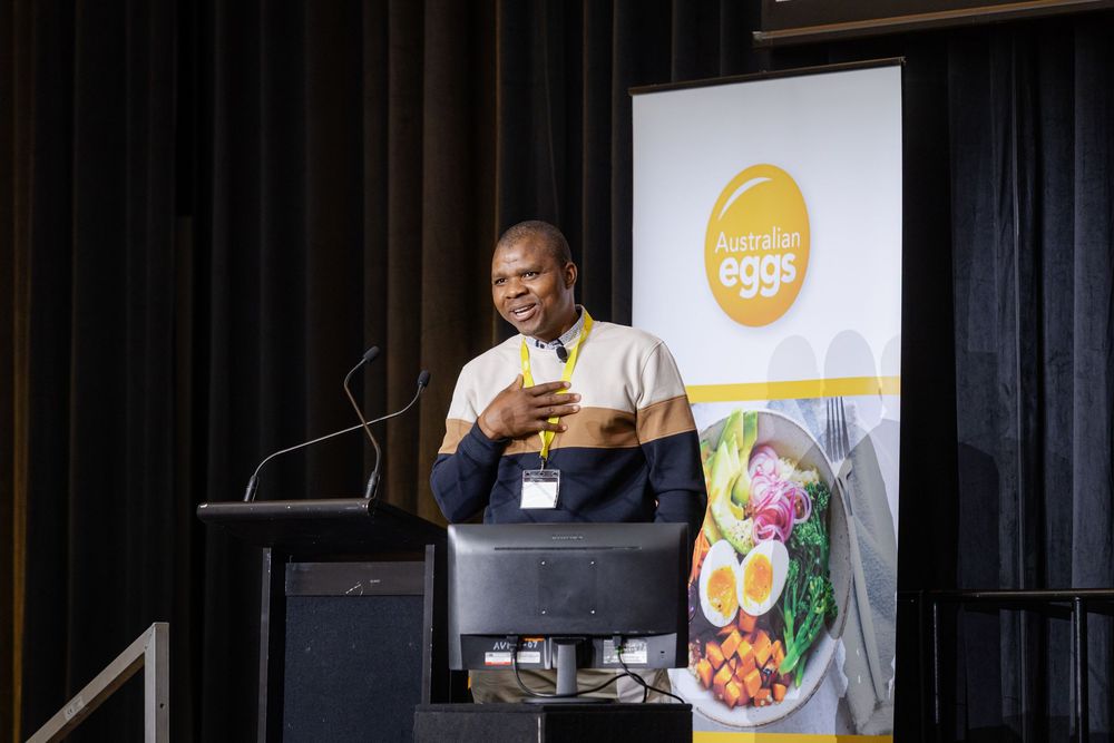 Speaker presenting at a conference podium, photography by Kirsten Graham, a Fremantle Conference Photographer