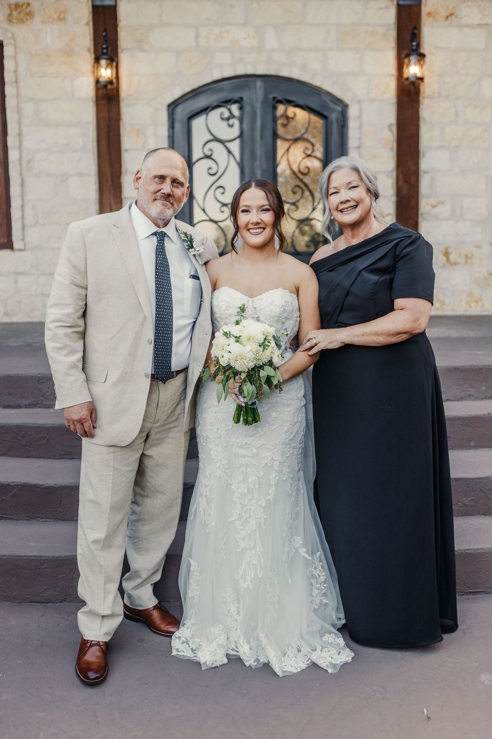 A series of wedding portraits showing a bride in a white lace dress with family members against a stone wall backdrop.