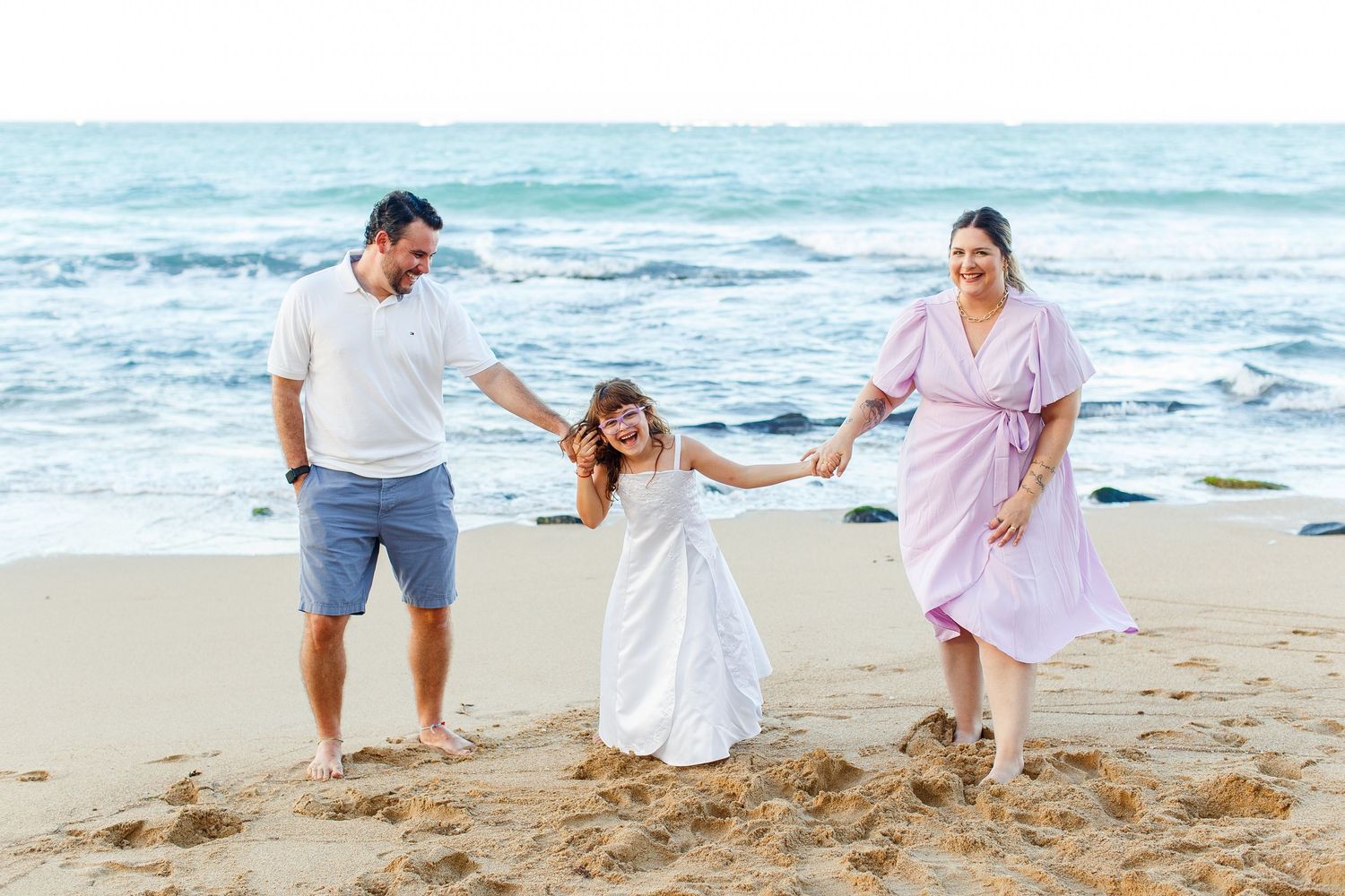 Portrait of a man, woman, and girl on the beach. San Juan, Puerto Rico.