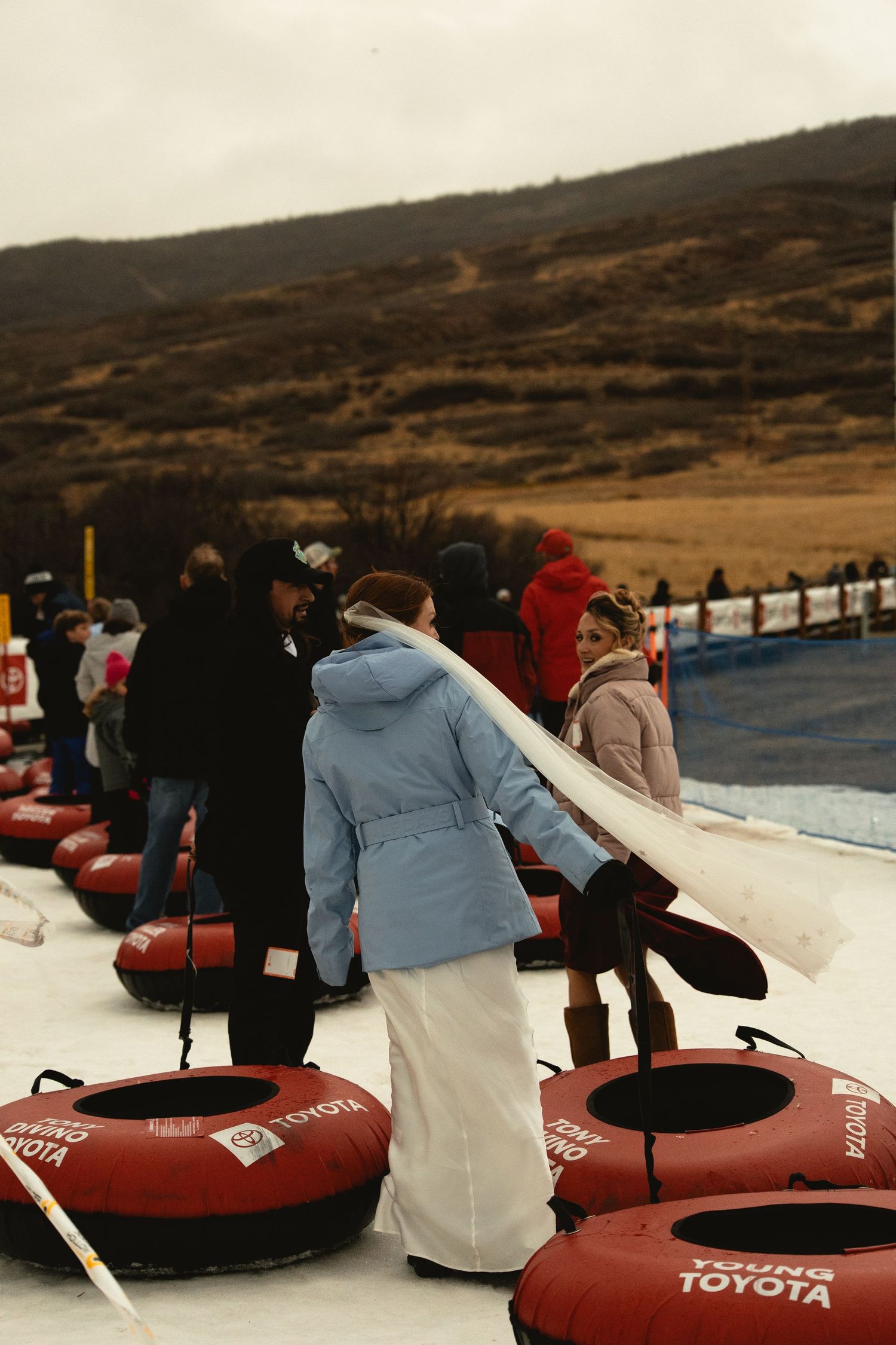 Bride with her guests going up magic carpet to tube