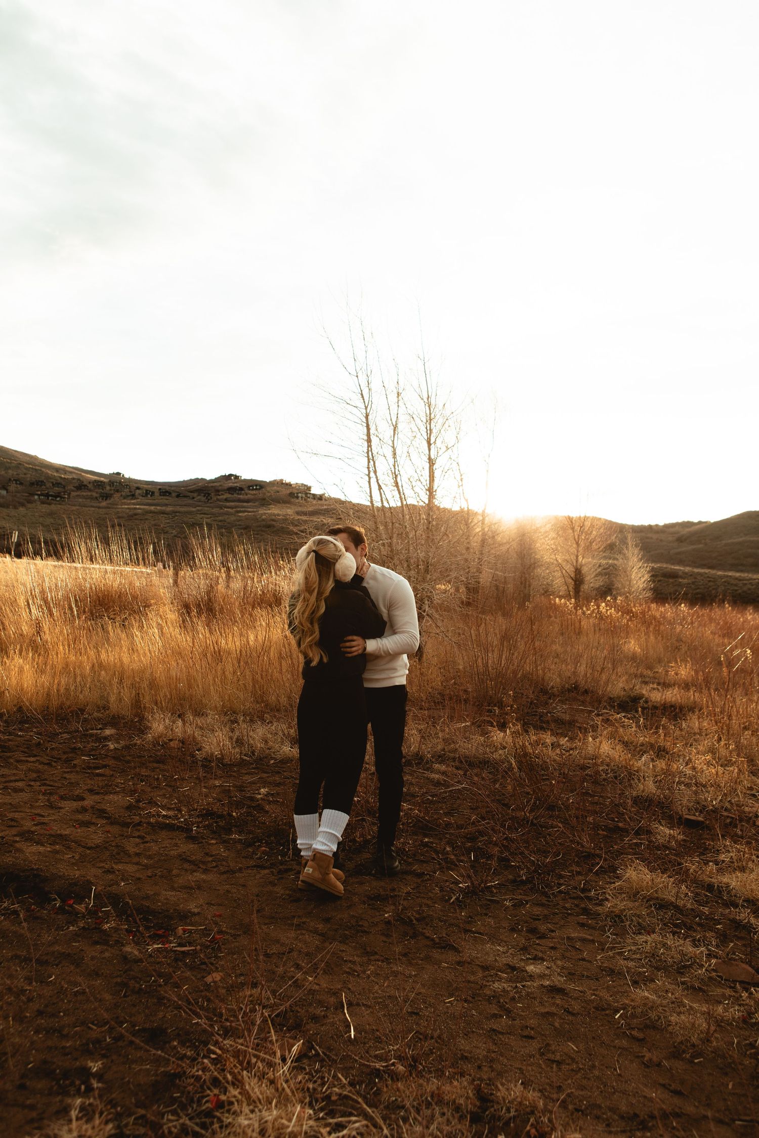 Kiss in the tall grass after engagment