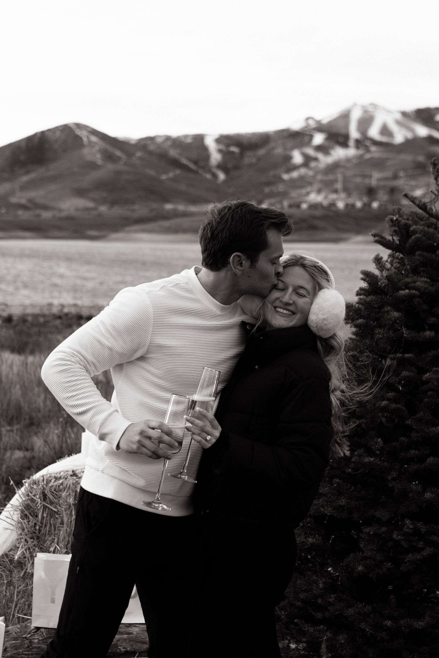 Cute forehead kiss at Jordanelle State Park winter engagement