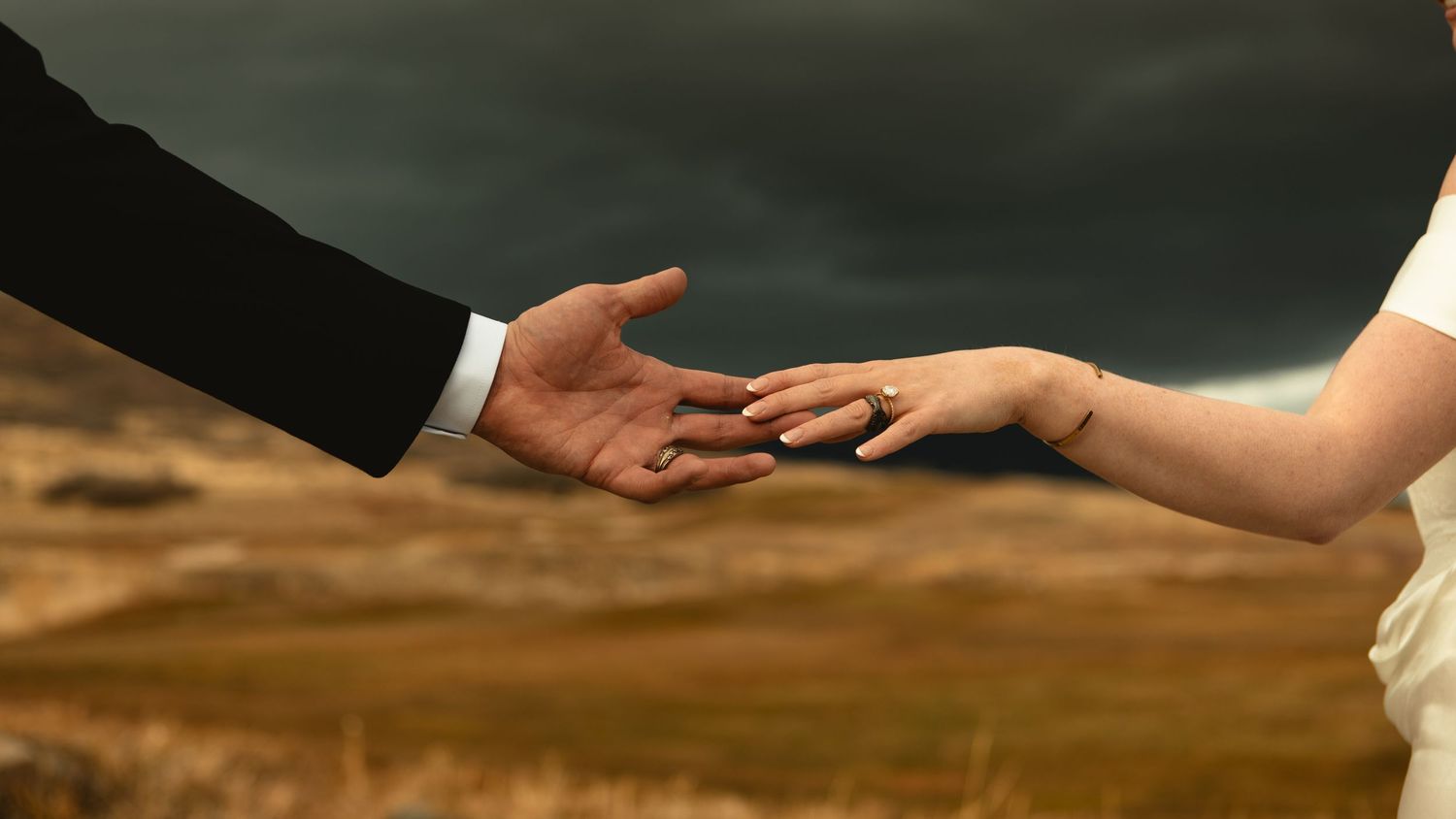 Intimate hand touch with new wedding rings