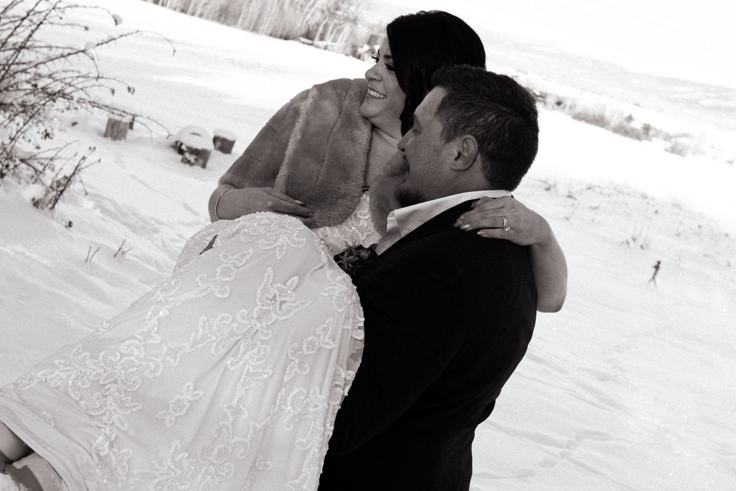 Groom carries bride inside