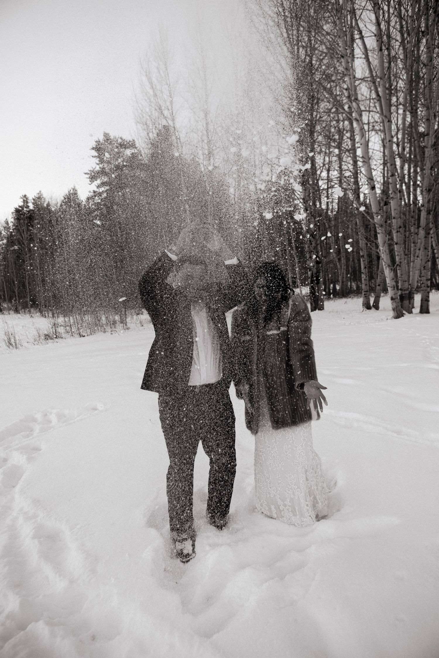 Throwing snow in the air during bridal session in the tetons