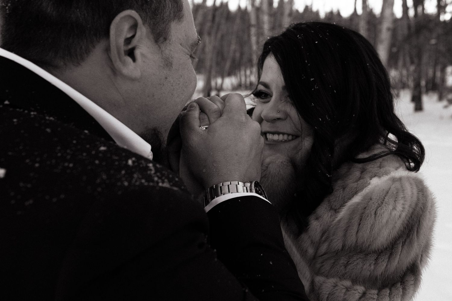 Groom warms up brides hands after chilly idaho elopement
