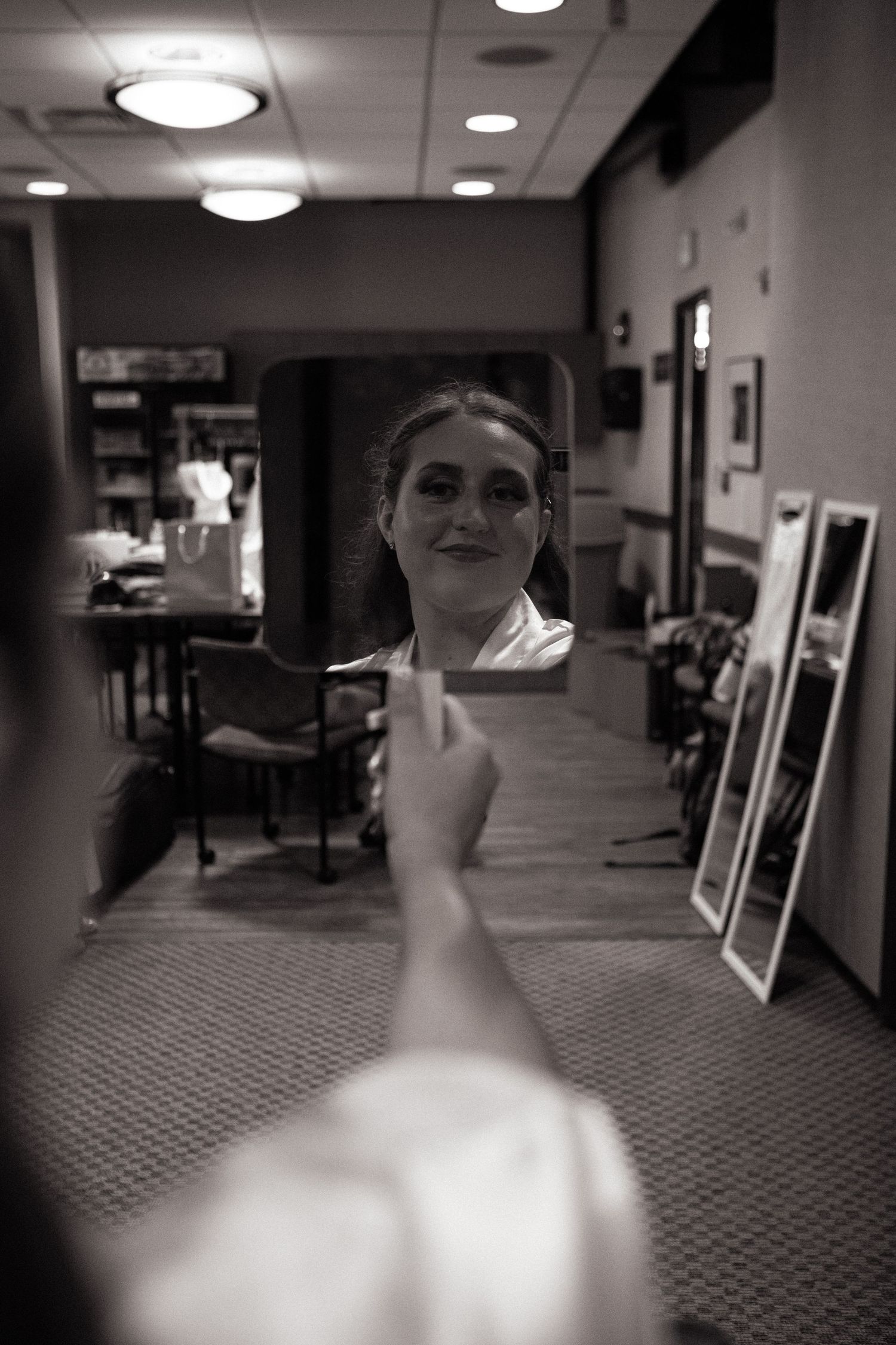 Bride admires herself in front of mirror