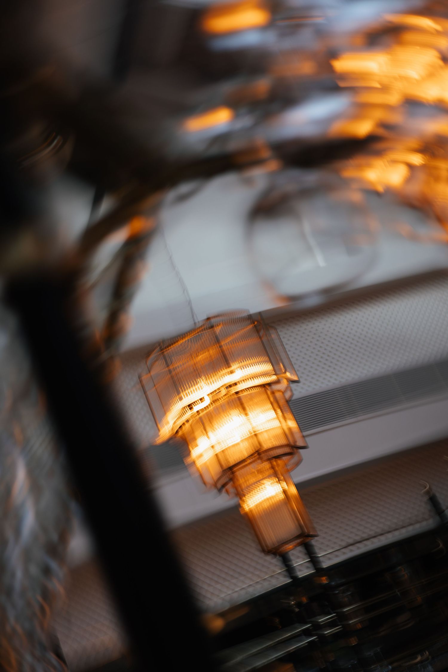 Warm ambient lighting creates a glowing effect through decorative glass fixtures.