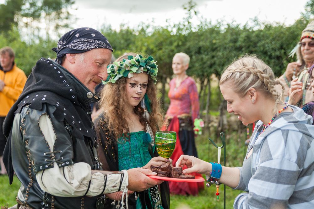 Cakes being handed out at an outdoor pagan baby naming ceremony.