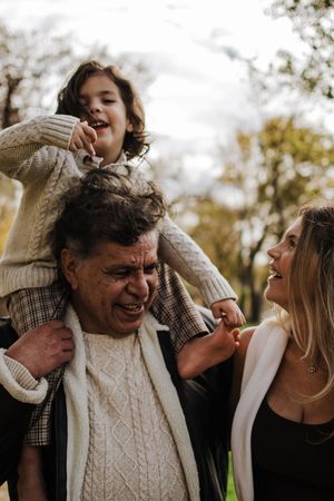 Candid family interactions filled with laughter and joy in an autumn outdoor setting.