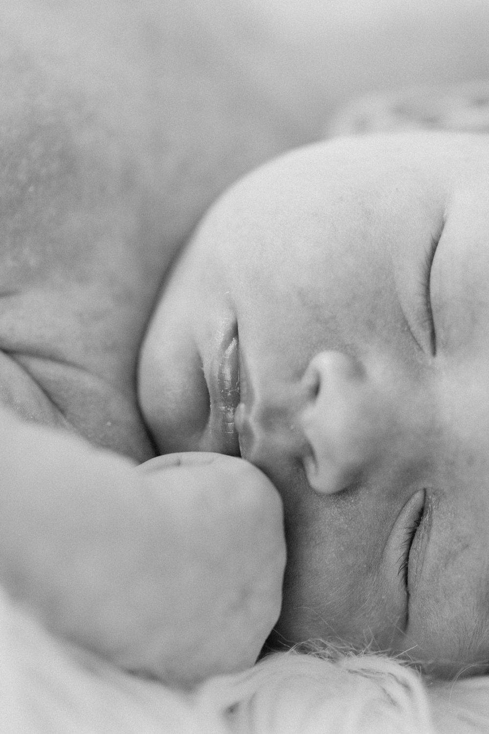 A series of peaceful black and white close-up profiles showcasing a sleeping baby in soft gentle lighting.