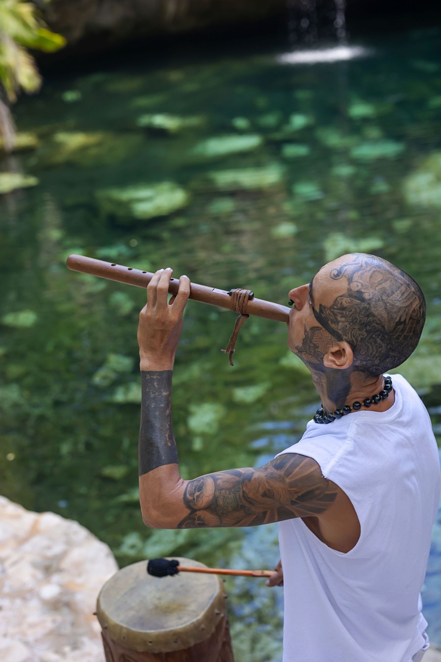 A photographer in white clothing takes pictures of nature and wildlife in different outdoor settings.