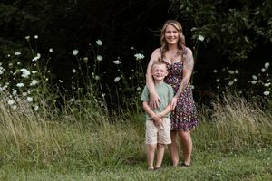 A sweet outdoor photo session among white wildflowers in a natural field setting.
