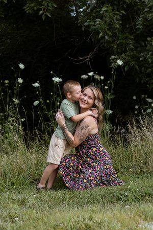An intimate portrait moment captured among wildflowers in a summer field.