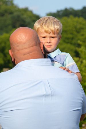 Outdoor portrait session showing close interactions against natural lake backdrop.