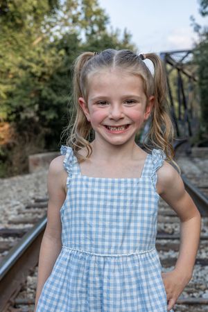 Close-up shots of person in blue gingham dress showing joyful expressions.