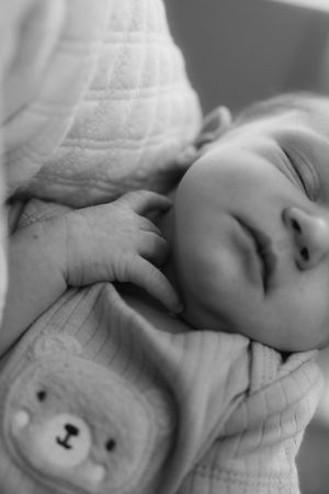 Black and white close-up shots of a newborn baby's face and features.