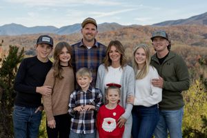 Multi-generational family portrait session against autumn mountain scenery.