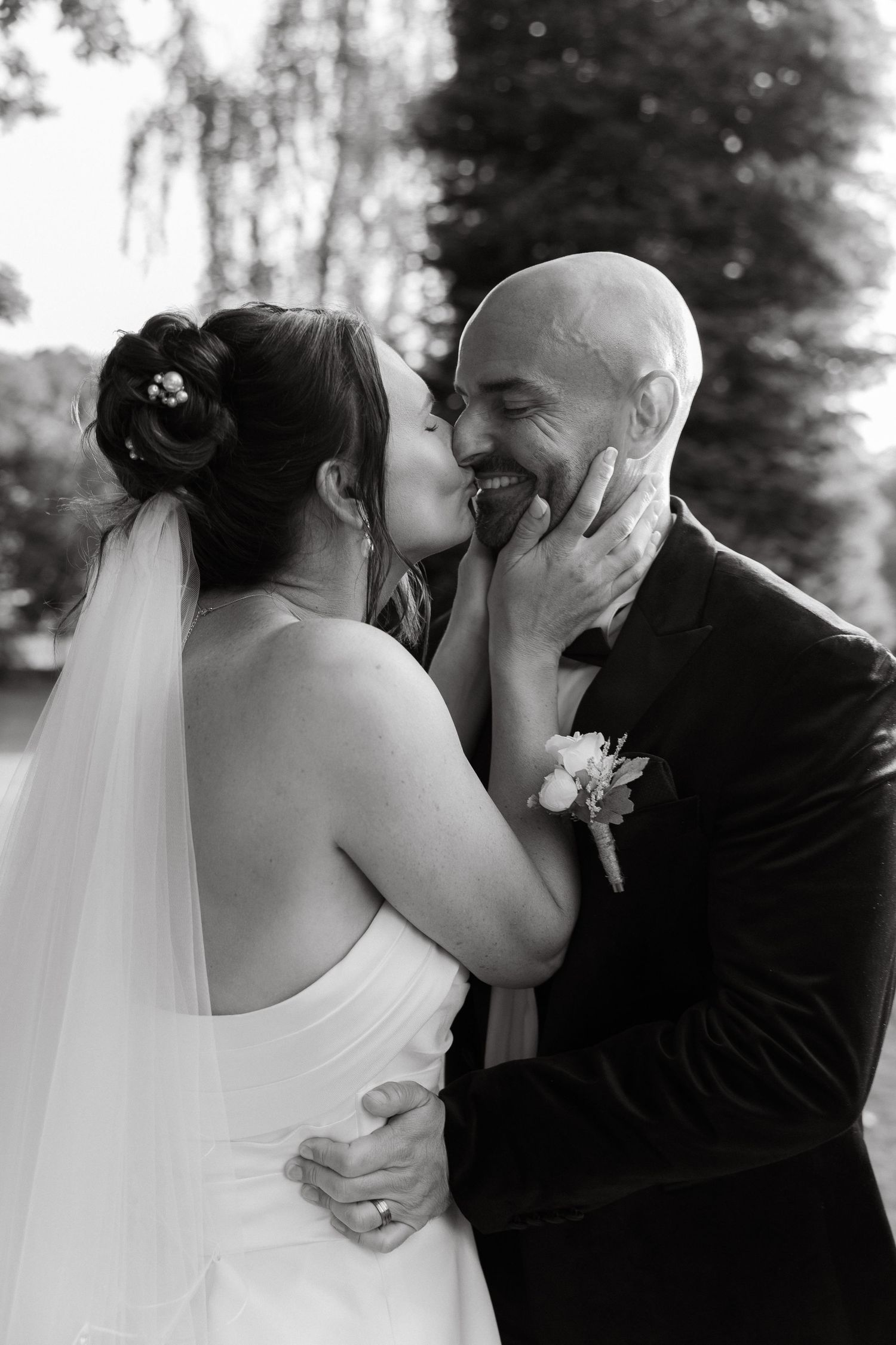 Romantic wedding portraits captured in black and white against a natural backdrop.