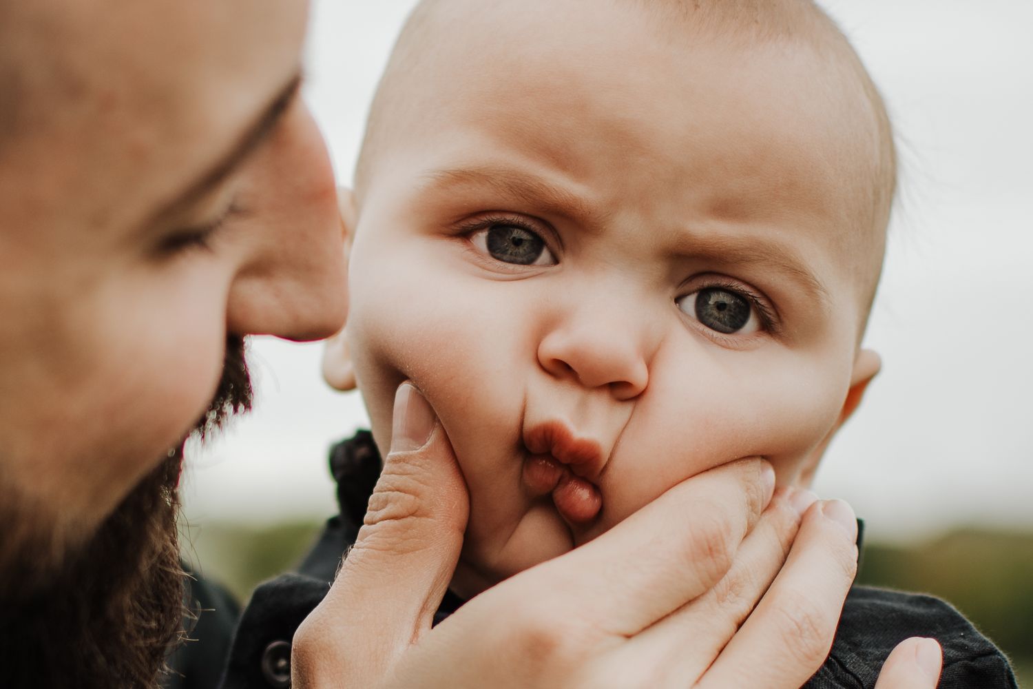 Close-up emotional moment captured in gentle lighting. Crowley Family Photographer