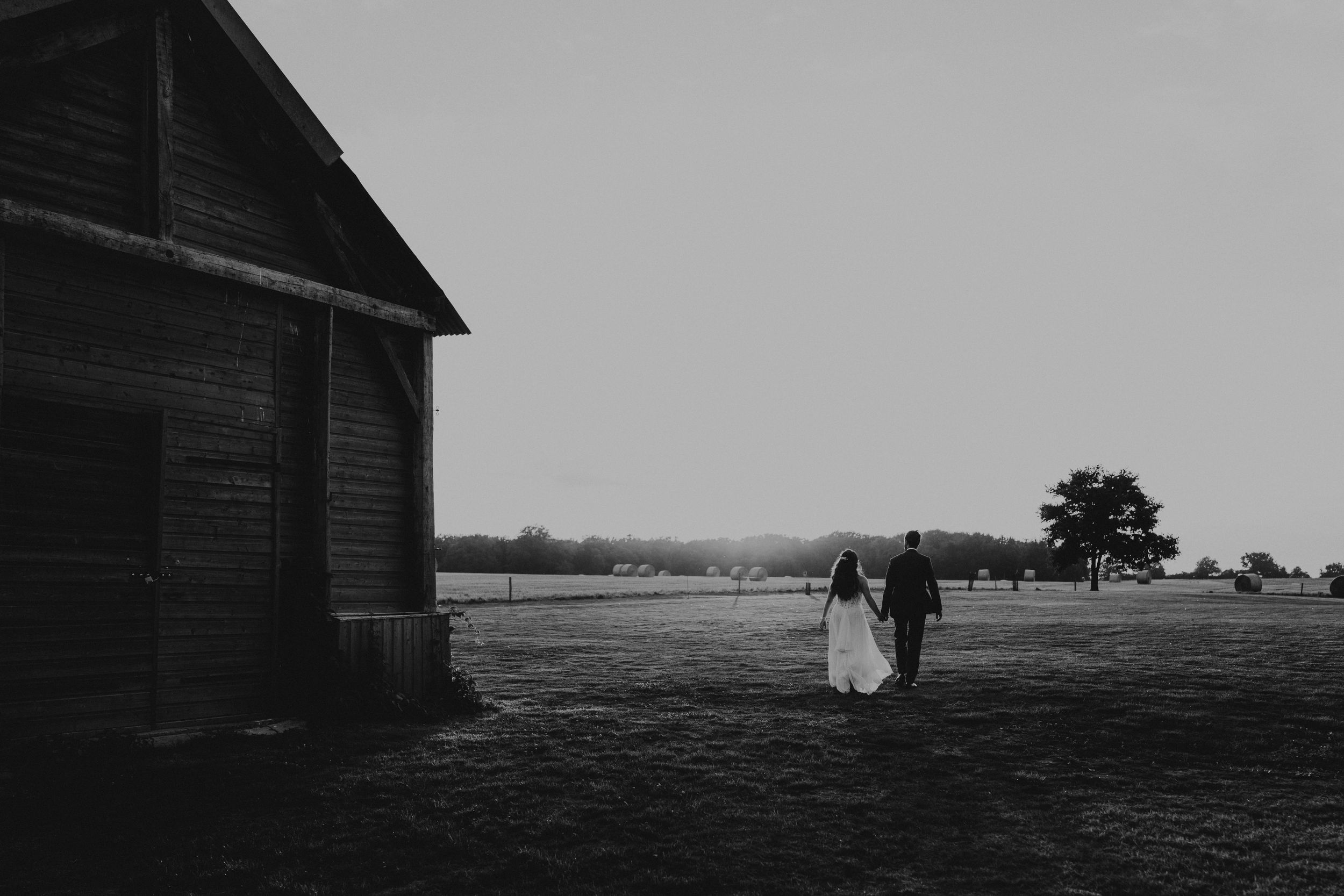 A romantic dance silhouette under stone archways with warm lighting.