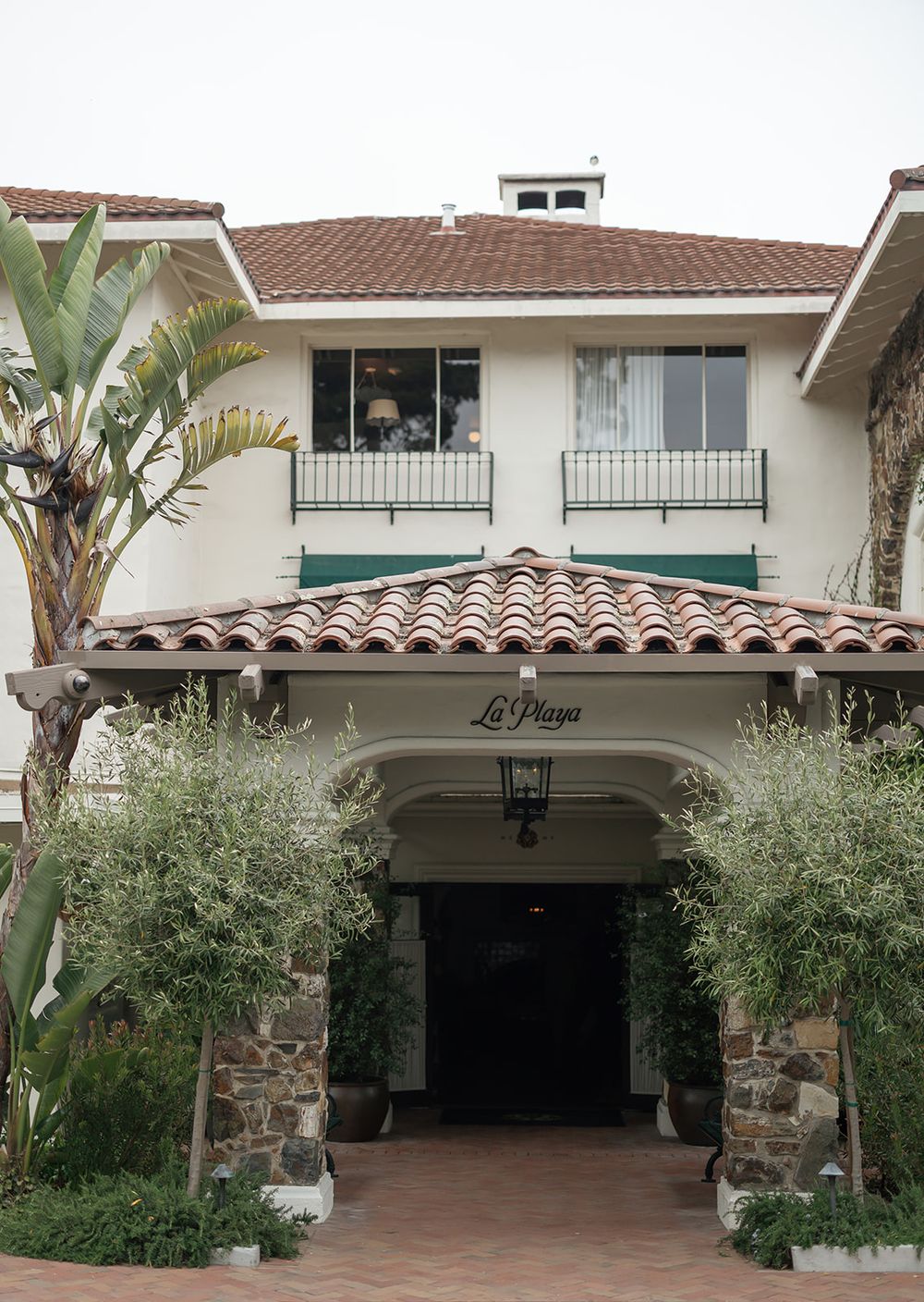 La Playa hotel entrance with Spanish tile roof and Mediterranean architecture.
