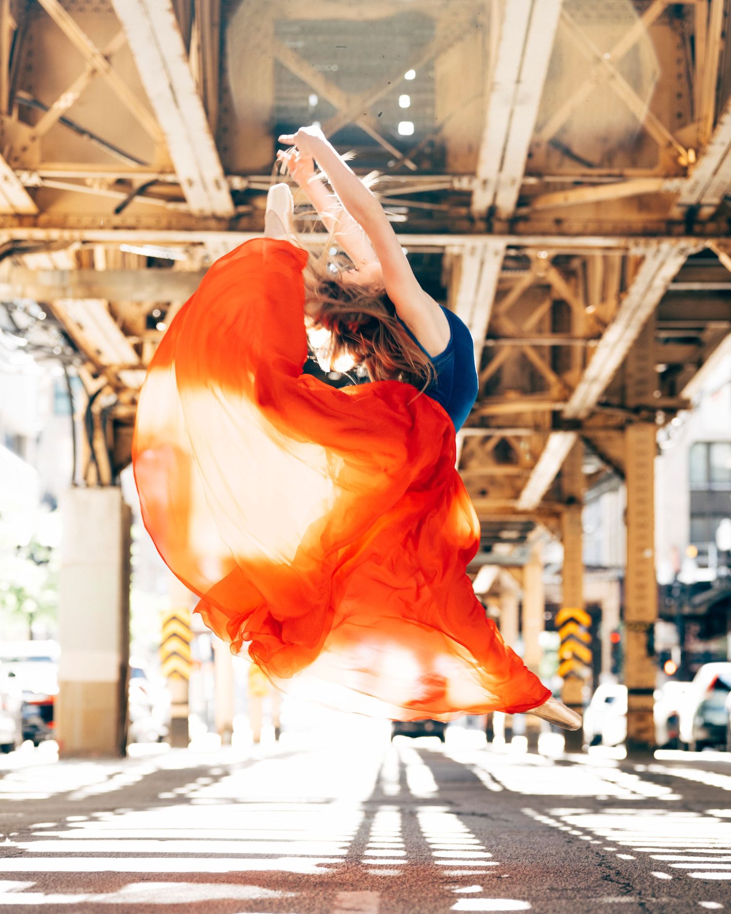 chicago dance photography Dancer performing firebird under Chicago train tracks on lake street joffrey summer intensive