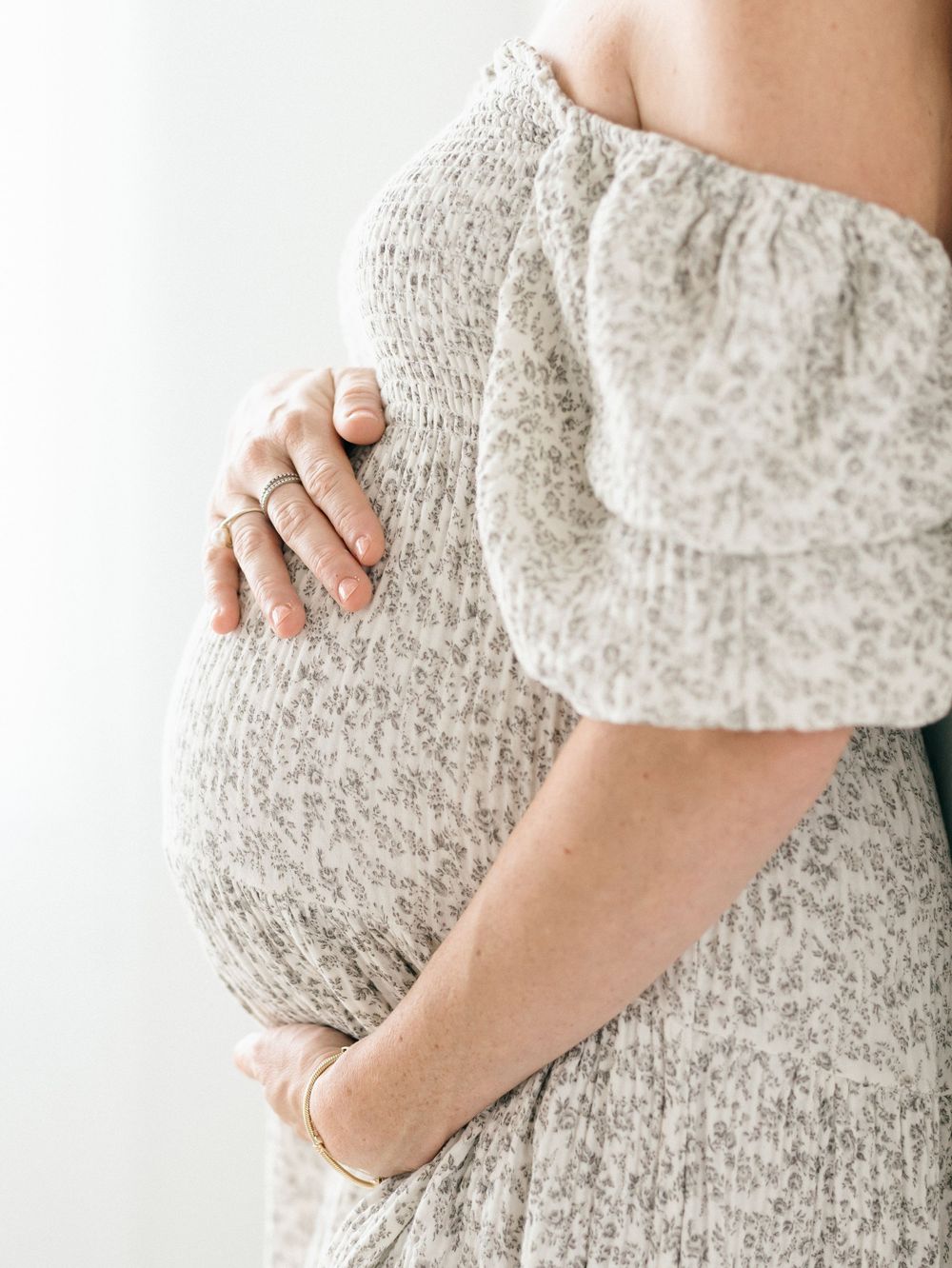 Close-up of baby bump during timeless maternity shoot in Wall, New Jersey.