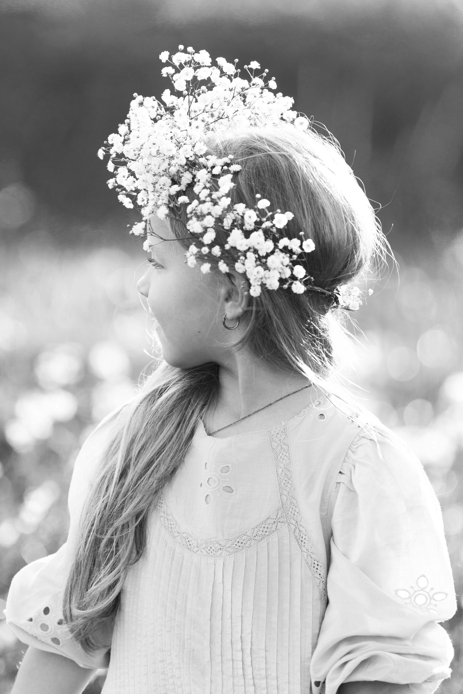 Black and white portrait with baby's breath flower crown and vintage dress.