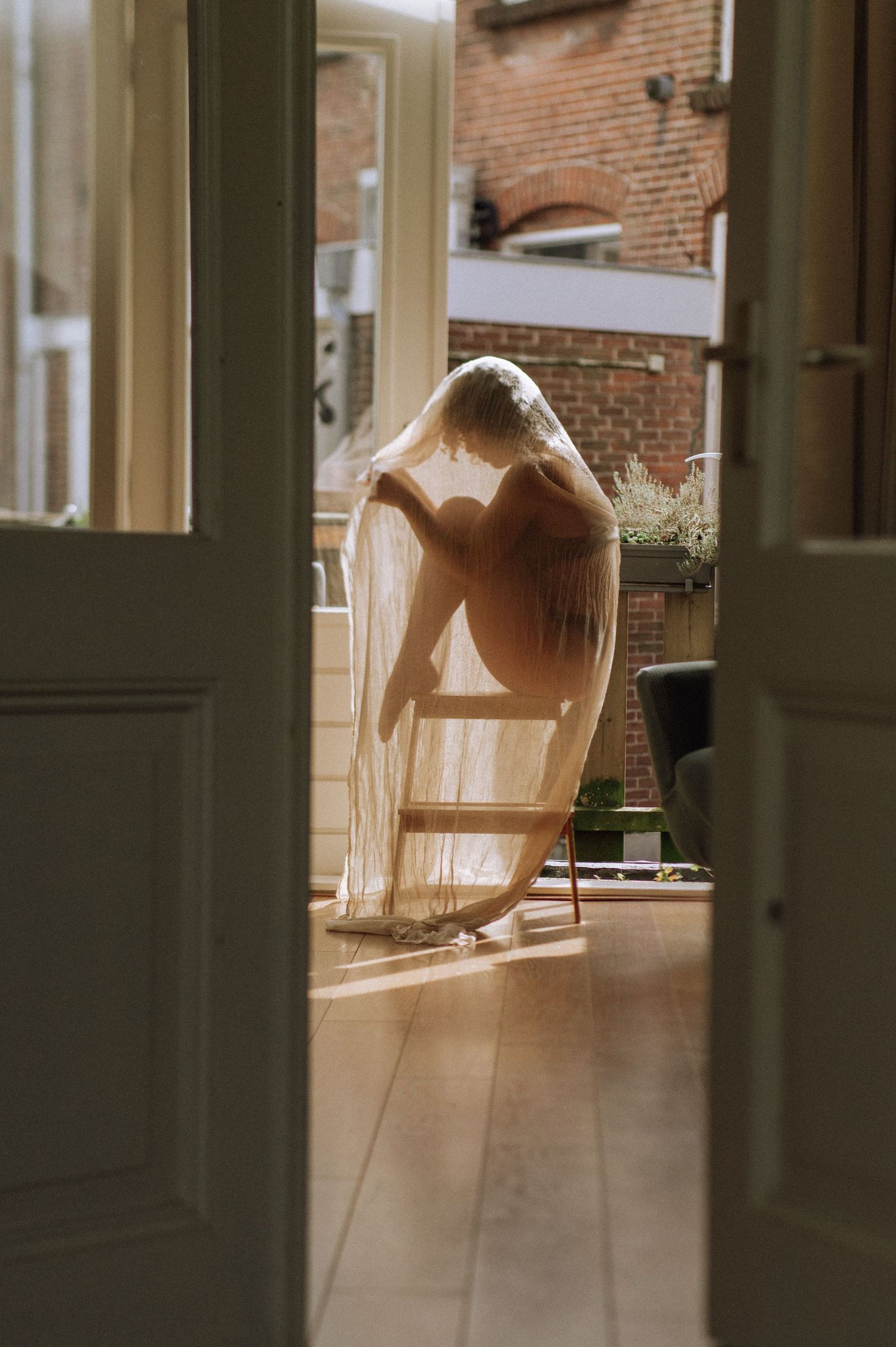 Introspective boudoir photography at home – a sensual portrait of a woman in lingerie.