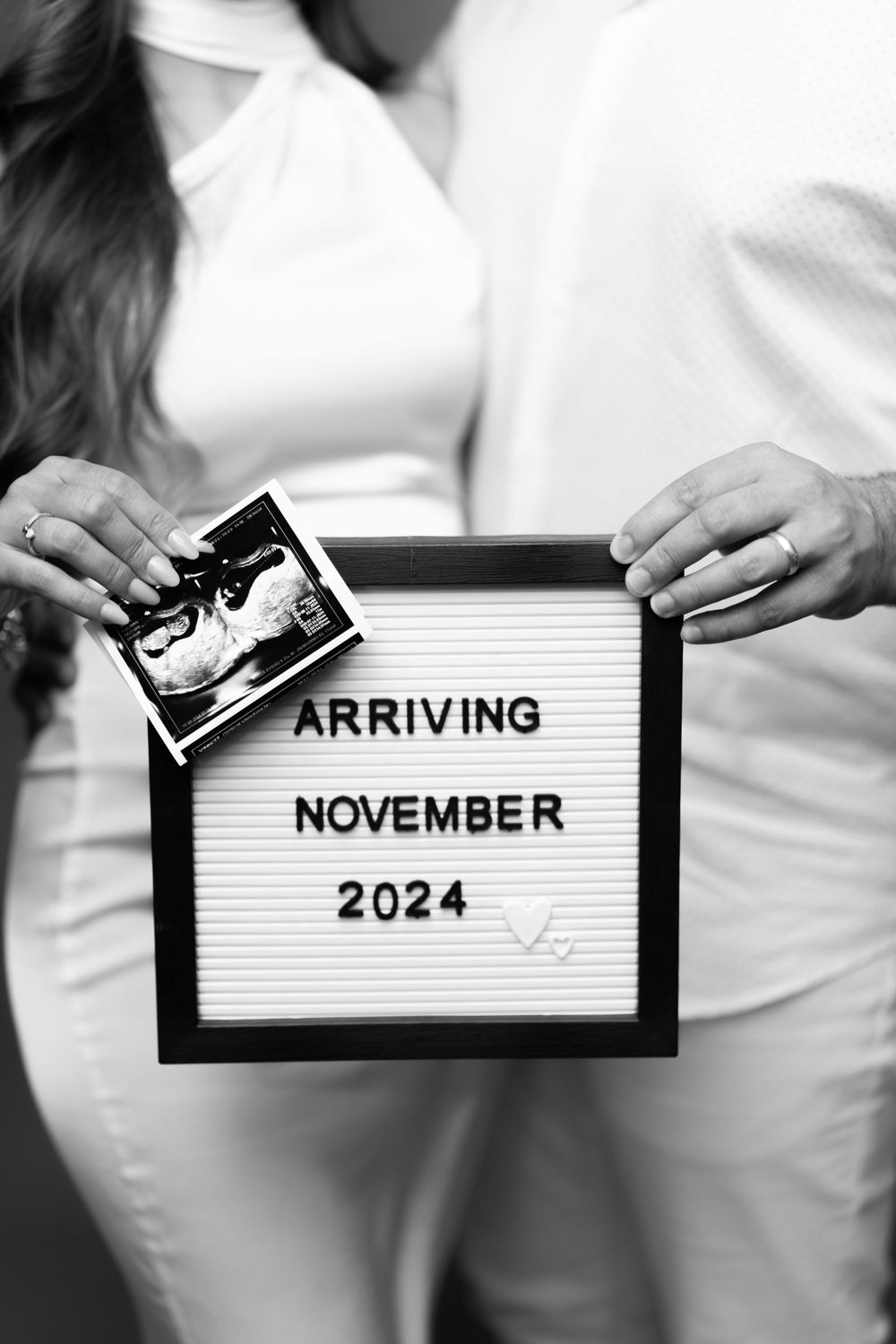 Black and white pregnancy announcement with letterboard showing November 2024 arrival date.