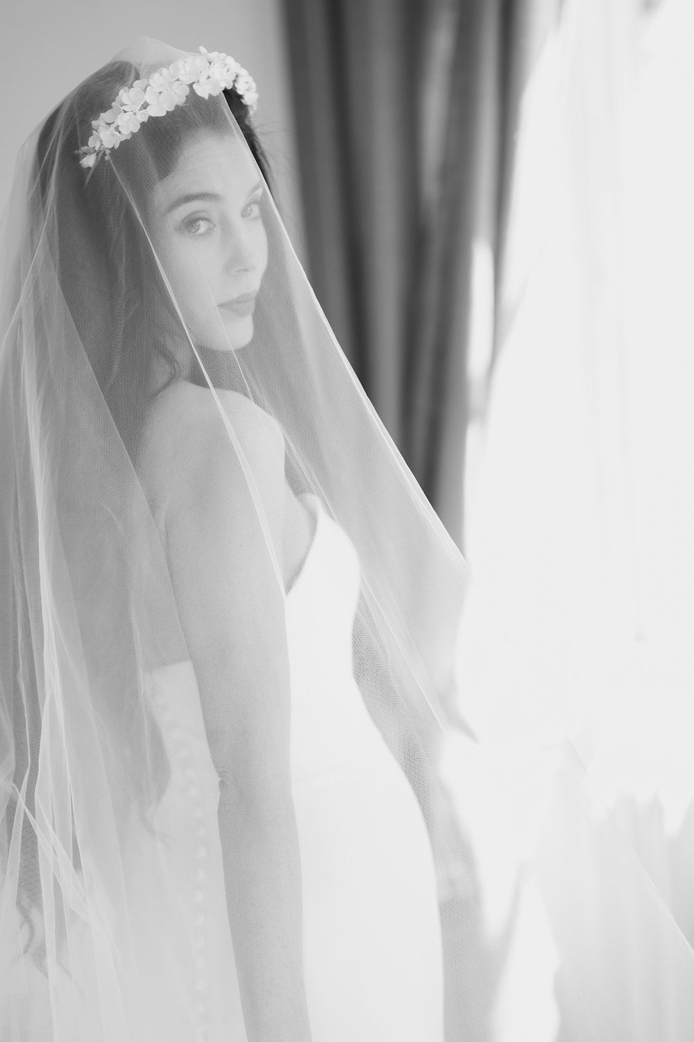 Ethereal black and white bridal portrait showing intricate veil and elegant wedding dress details near a window at The Halifax Club