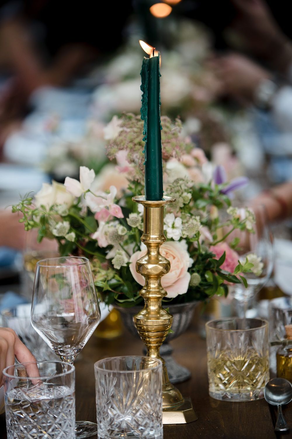 Elegant table setting with dark green taper candle at The Halifax Club