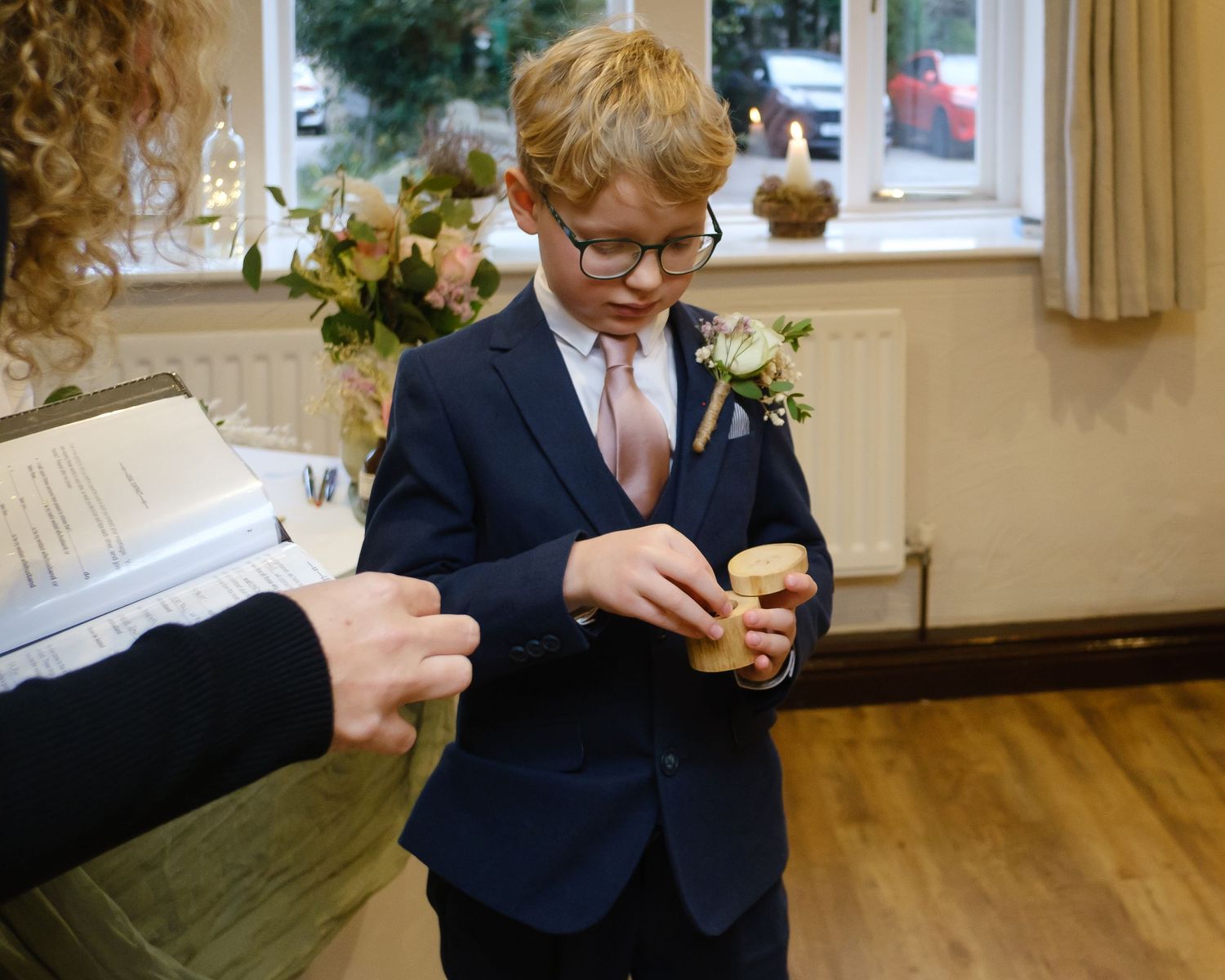 Brides young son doing his job as a ring bearer at the wedding of his mum at the Black Horse in Clifton