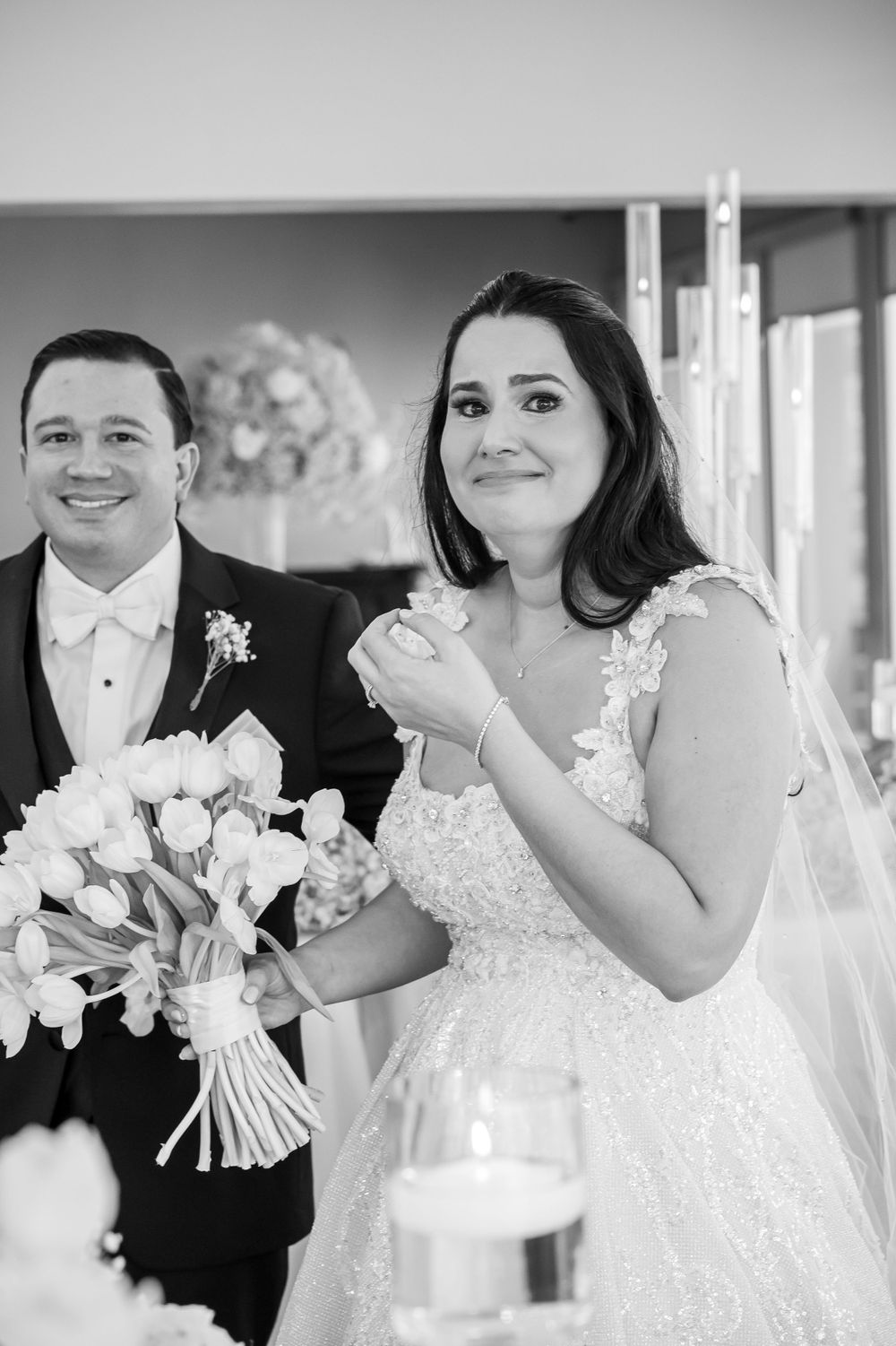 Black and white portrait of newlyweds sharing joyful moment.
