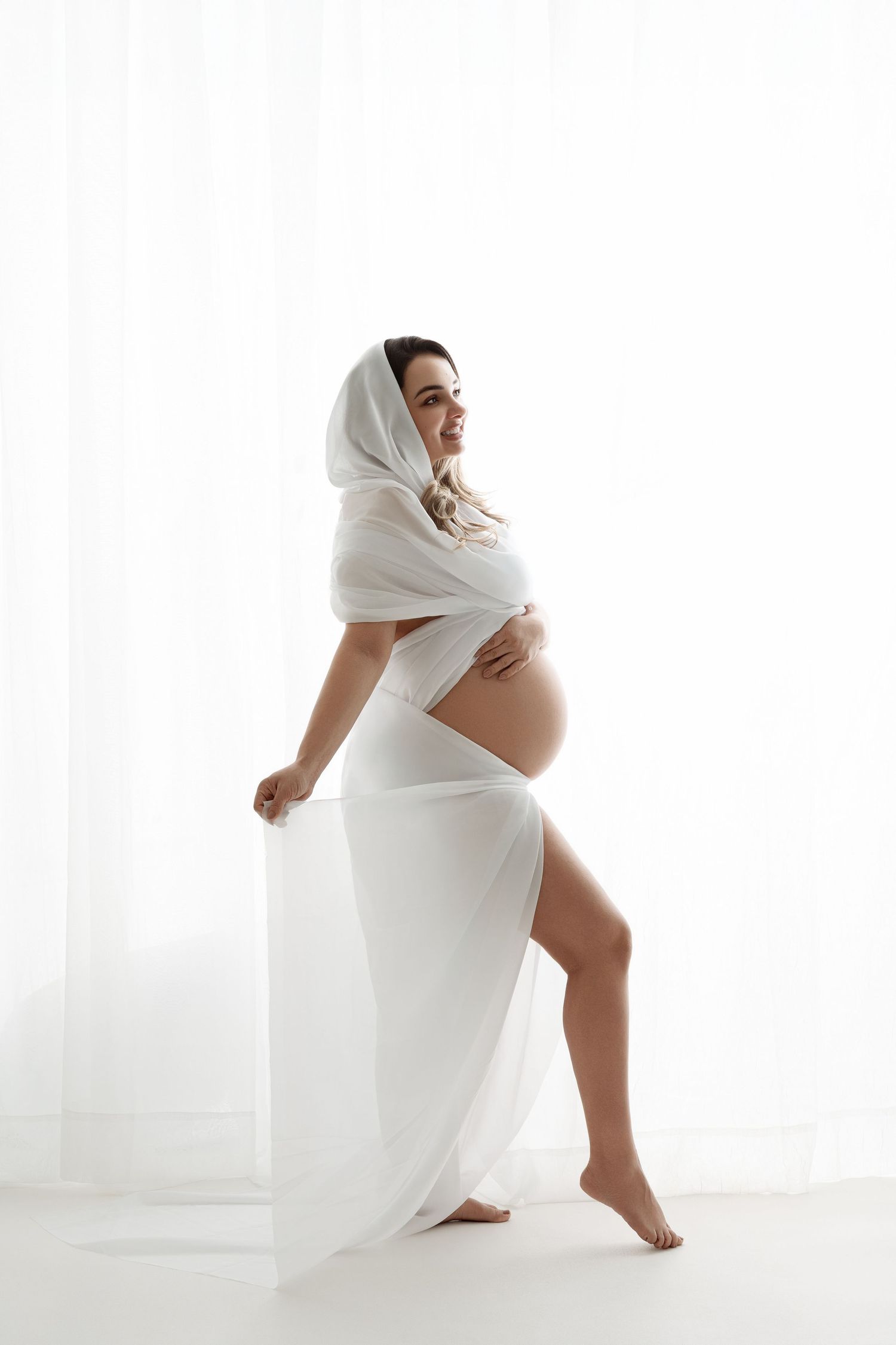 Intimate maternity portrait in white sweater showing pregnant belly. maternity photographer Paloma Schell Houston TX