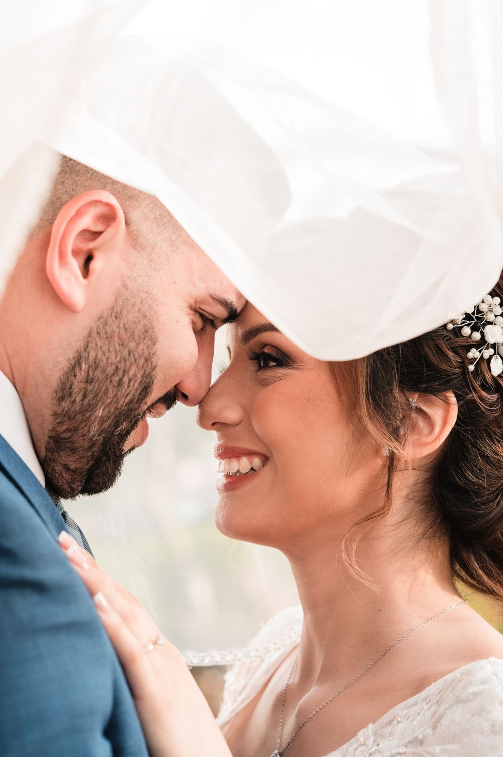 Tender moment captured between newlyweds under soft natural light.
