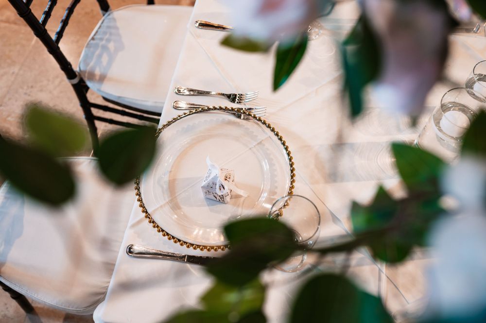 Close-up of wedding rings and jewelry details with soft focus floral elements.