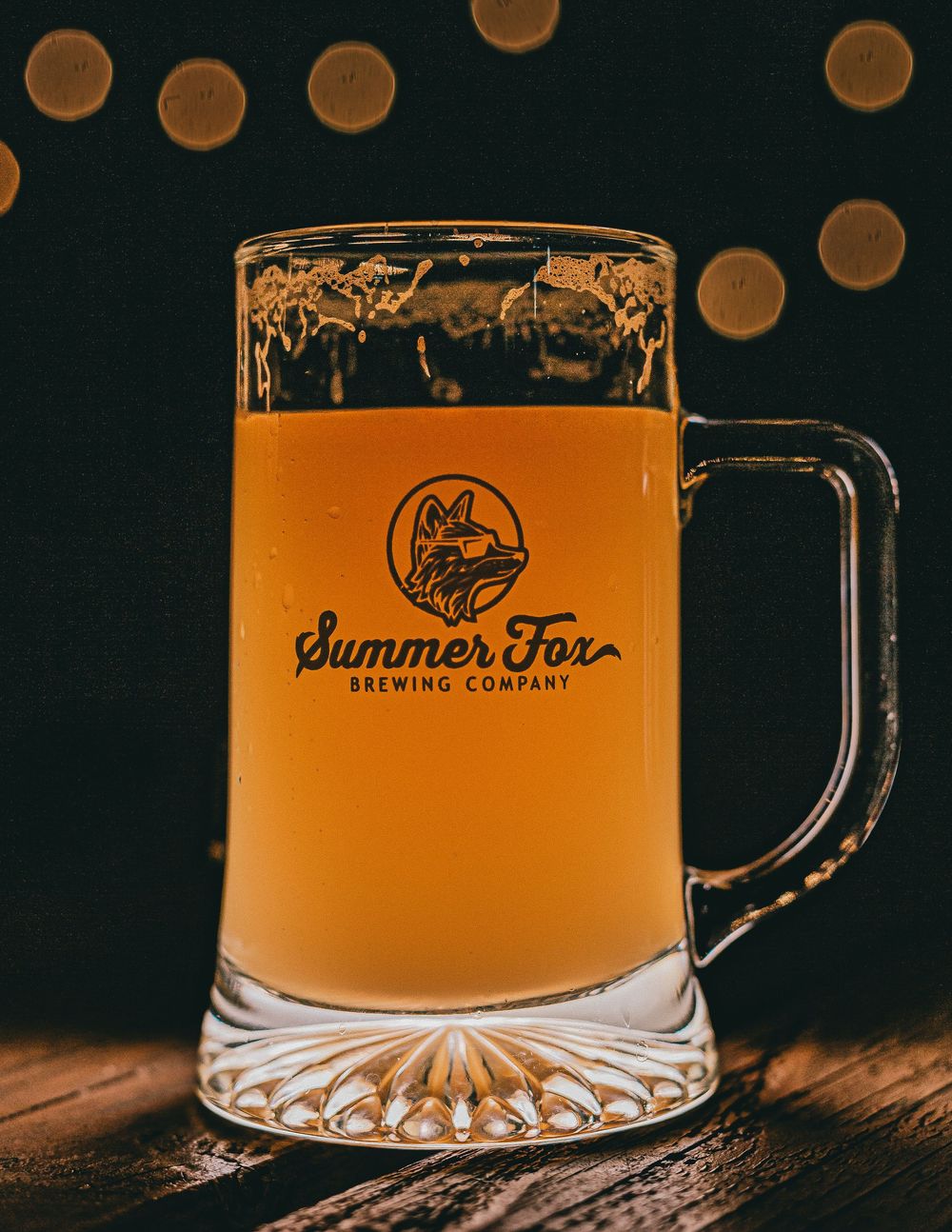 Summer Fox Brewing beer mug filled with amber beer, close-up shot